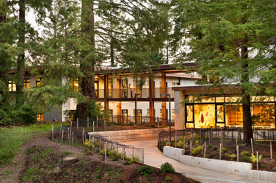 Exterior of student health center, surrounded by trees, at dusk