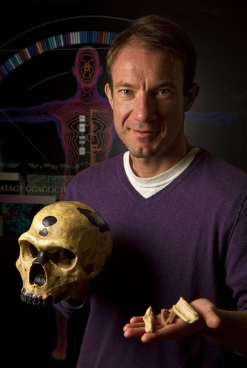 Ed Green holds a skull and other bones