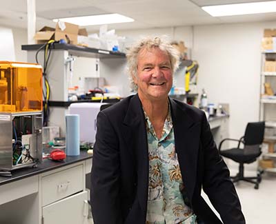 Haussler smiles for a portrait in the lab.
