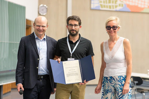 François Monard holding up prize certificate