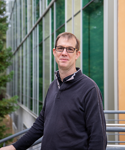 Portrait of James Davis in front of the Engineering 2 building