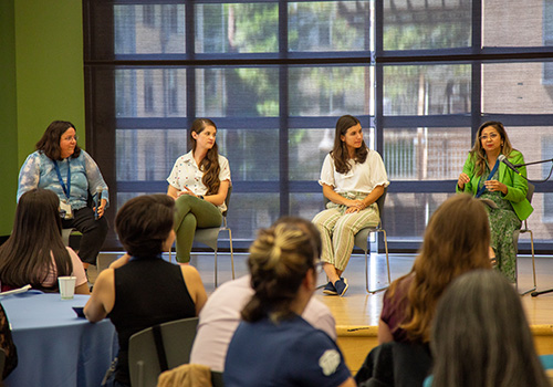 Four women panelists on stage.