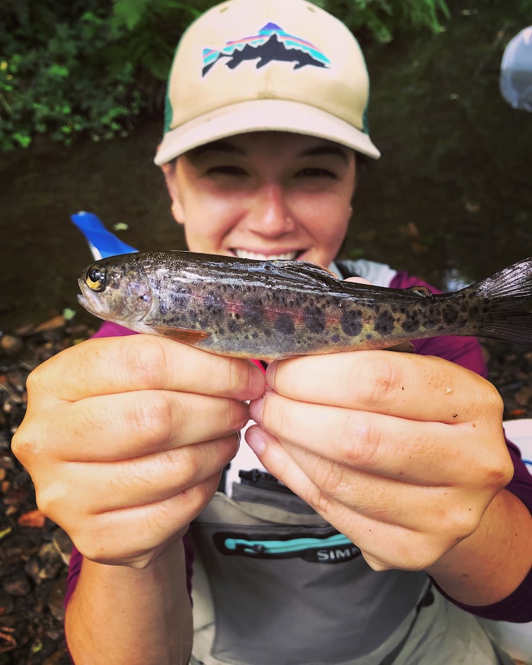 Researcher holding up a young salmon close to camera