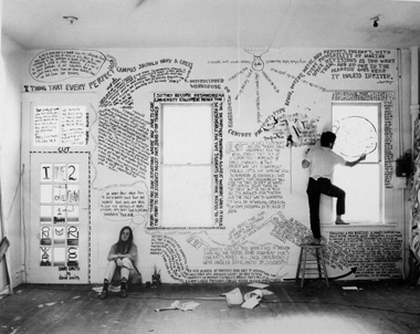Photo at the 50/50 show by Charley Stern (Crown '69). Pictured are Martha Brown (Merrill '70), seated, and Greg Calvert (Cowell '70 and Grad Div. '89) on the ladder. Original gelatin silver print, 1969 (reprinted as a 20 x 24 inch digital print for 50th anniversary). 