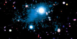 This deep image shows the nebula (cyan) extending across 2 million light-years that was discovered around the bright quasar whose energetic radiation makes the surrounding intergalactic gas glow, revealing the morphology and physical properties of a cosmic web filament. 