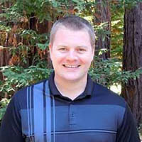 Jeremy west in front of trees