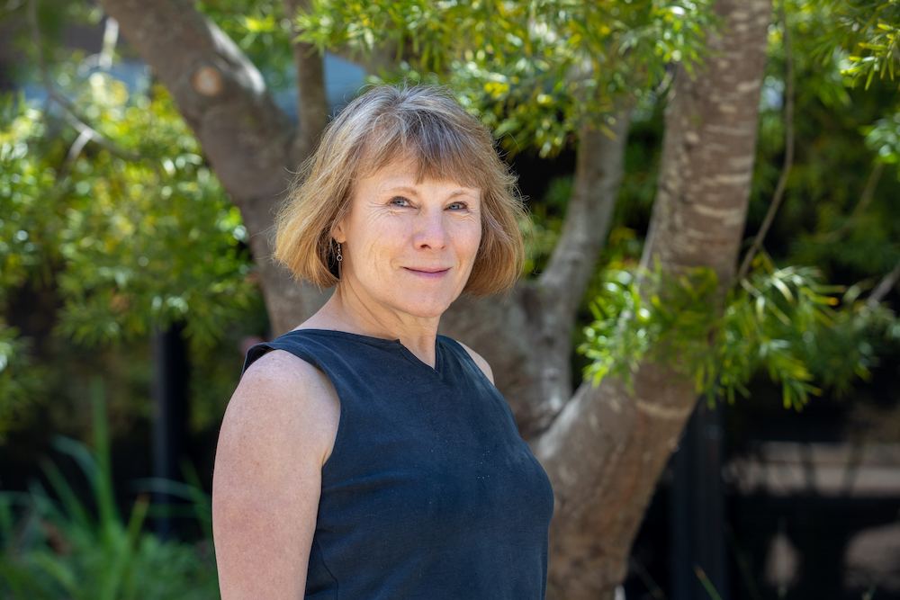 Photograph of researcher Melissa Cline standing in front of a tree