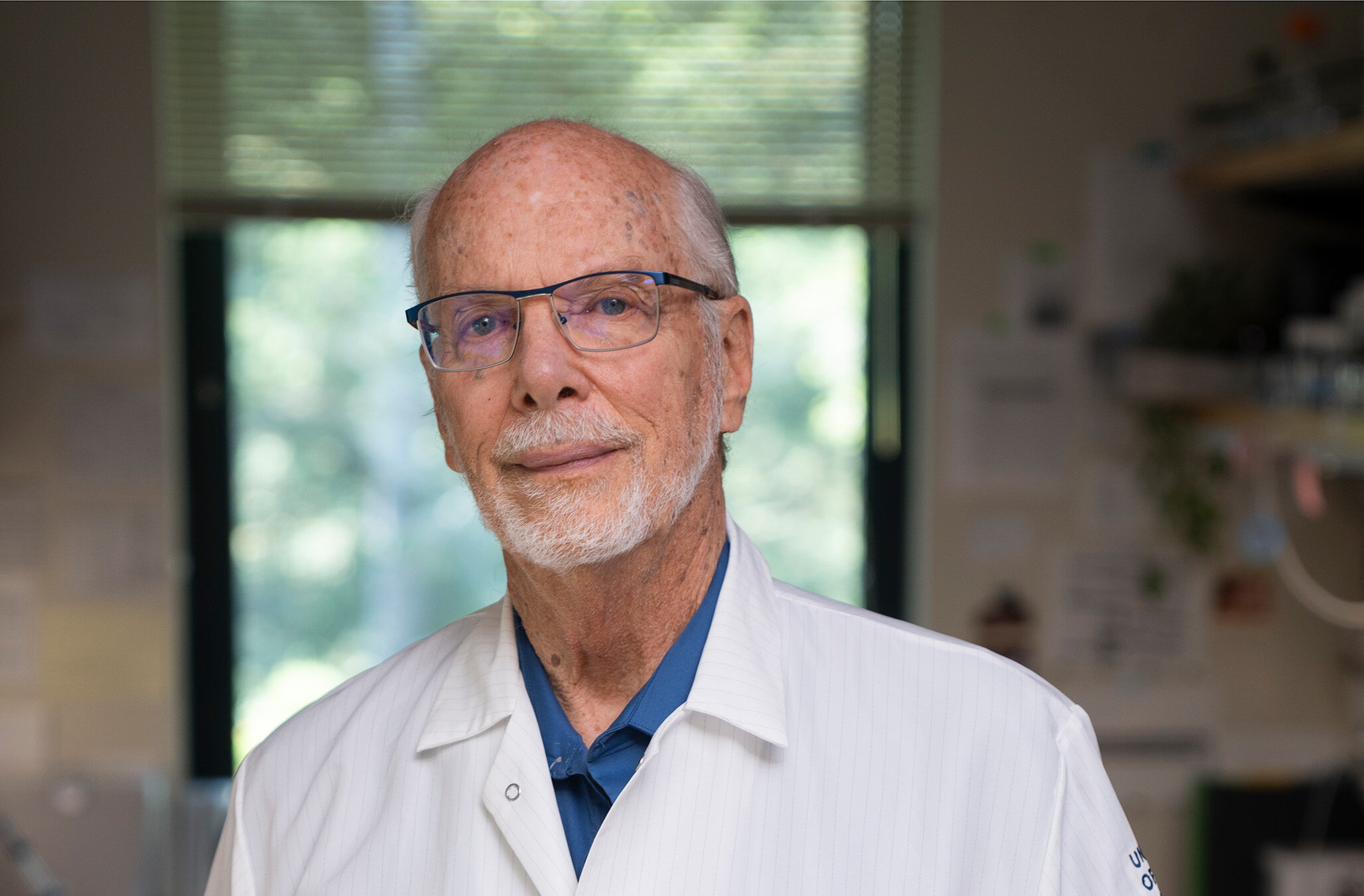Portrait of Dave Deamer in a lab coat