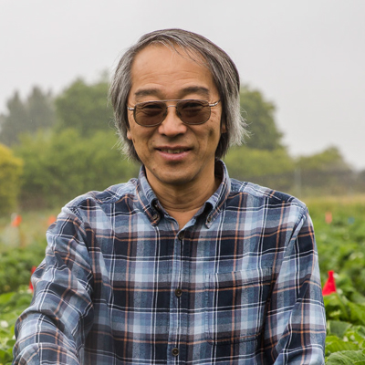 Portrait of Joji Muramoto in agricultural field