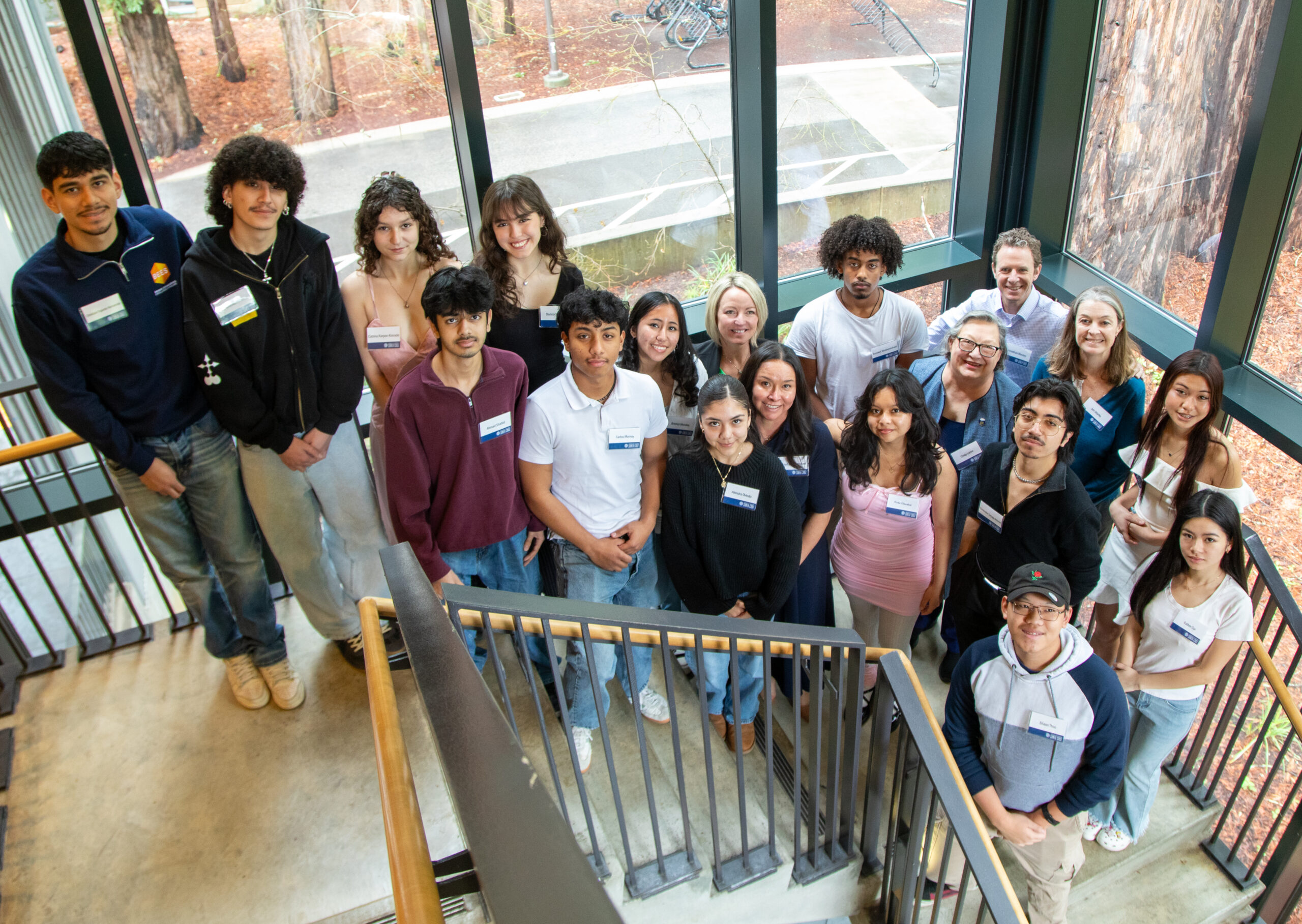 Members of the inaugural cohort of Sabatte Family Scholars stand in the stairwell at University Center. They are pictured along with Chancellor Cindy Larive, members of Financial Aid staff, and Jonathan Westen and Jen Starks, members of Richard Sabatte's family.