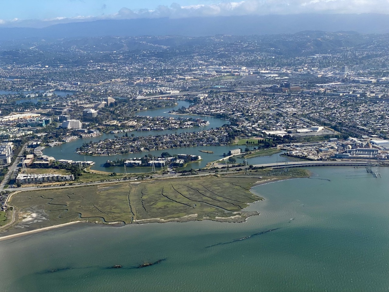 Aerial view of tidal marsh in front of low-lying homes along San Francisco Bay