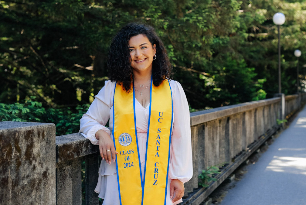 Carmen Garcia wearing a 2024 graduation stole on the UC Santa Cruz campus