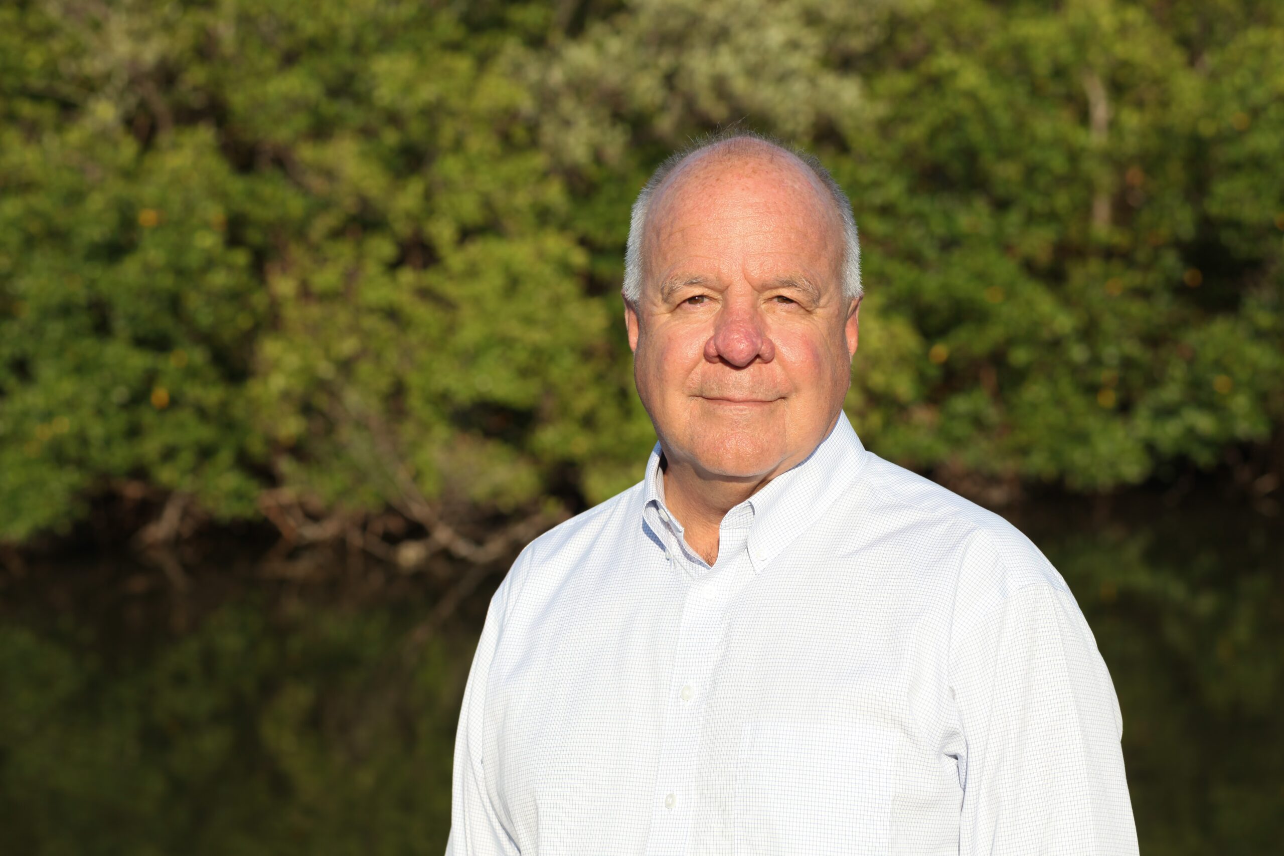 A head shot of William "Monty" Graham wearing a collared button-down shirt. He is looking directly at the camera.