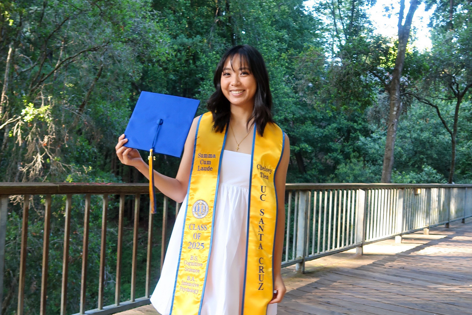 Portrait of Chelsey Tien wearing 2025 graduation stole that says "Summa Cum Laude"