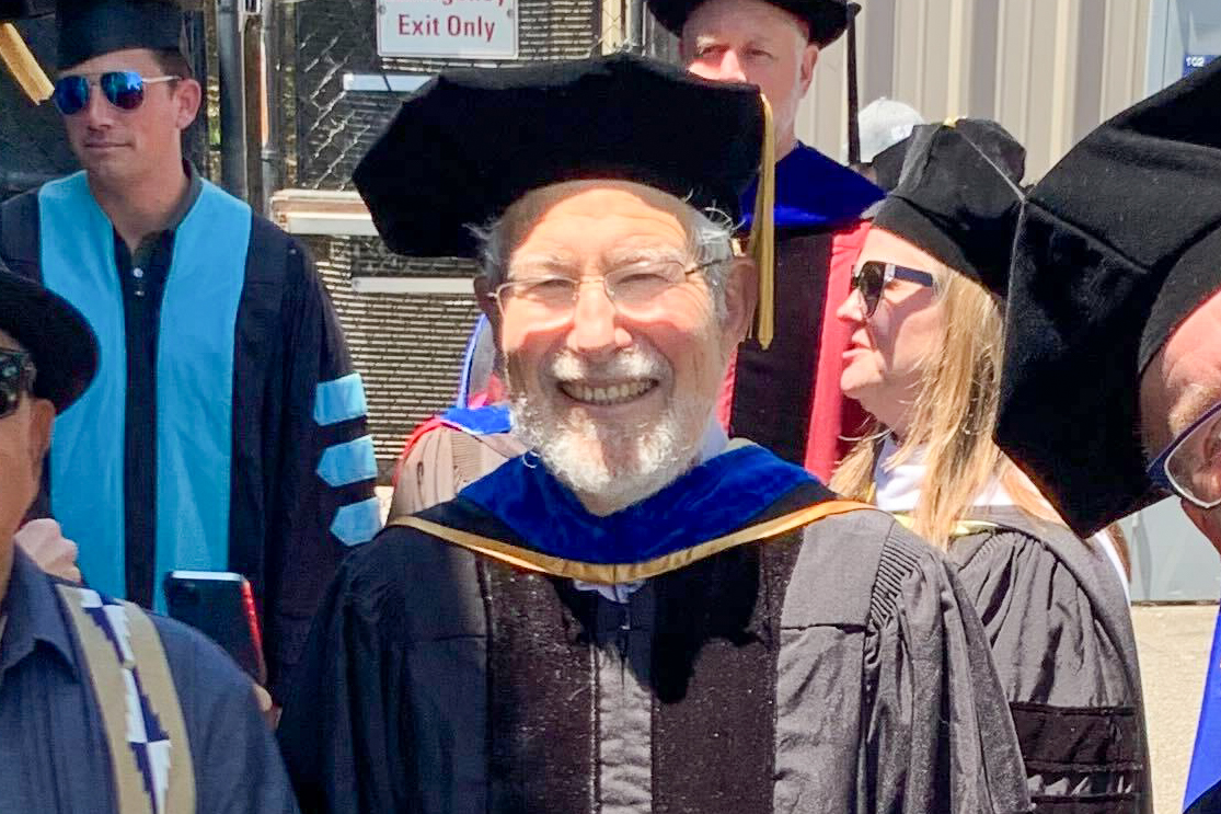 Mike Rotkin wearing graduation regalia