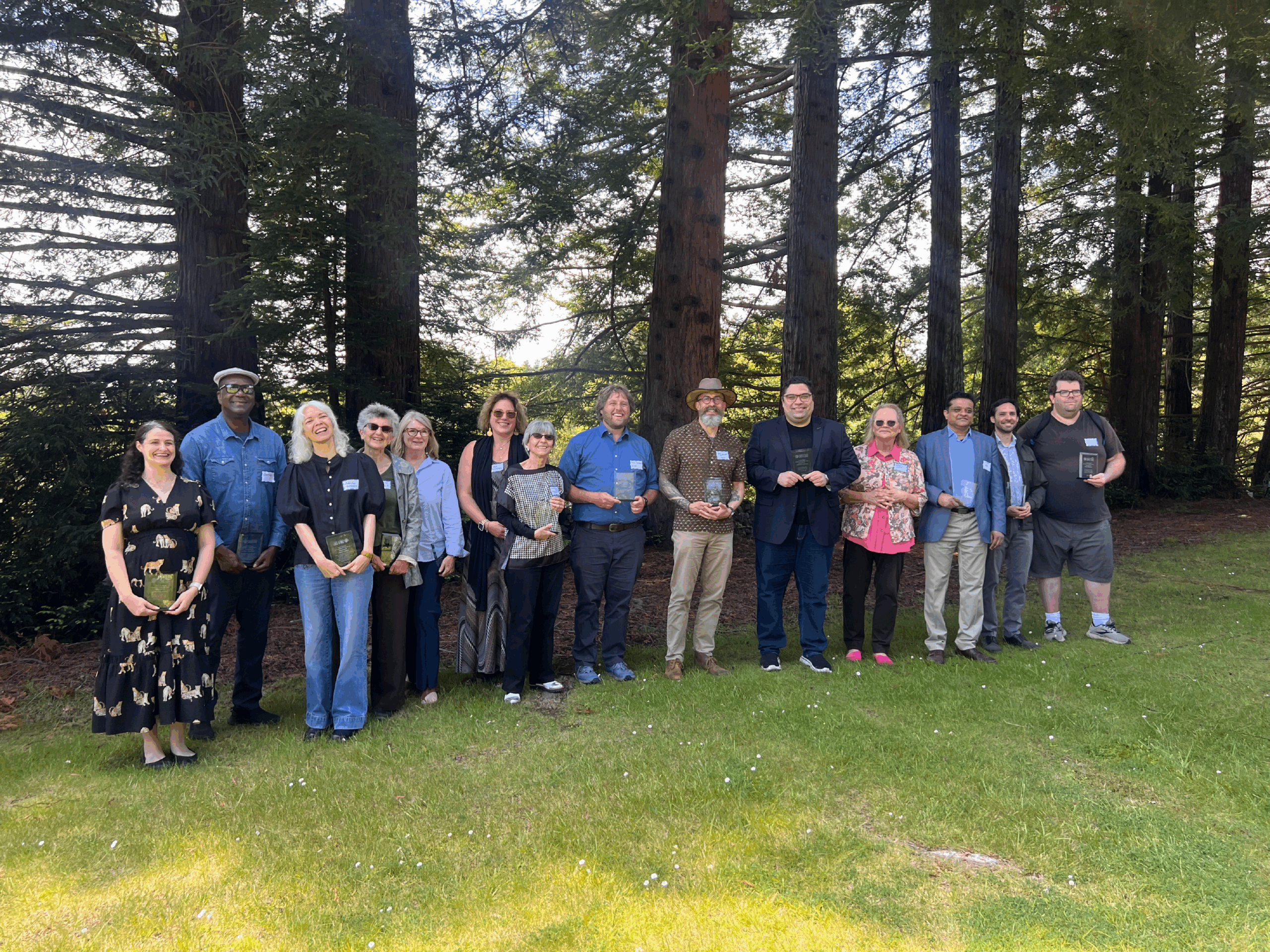14 Faculty members standing in front of trees.