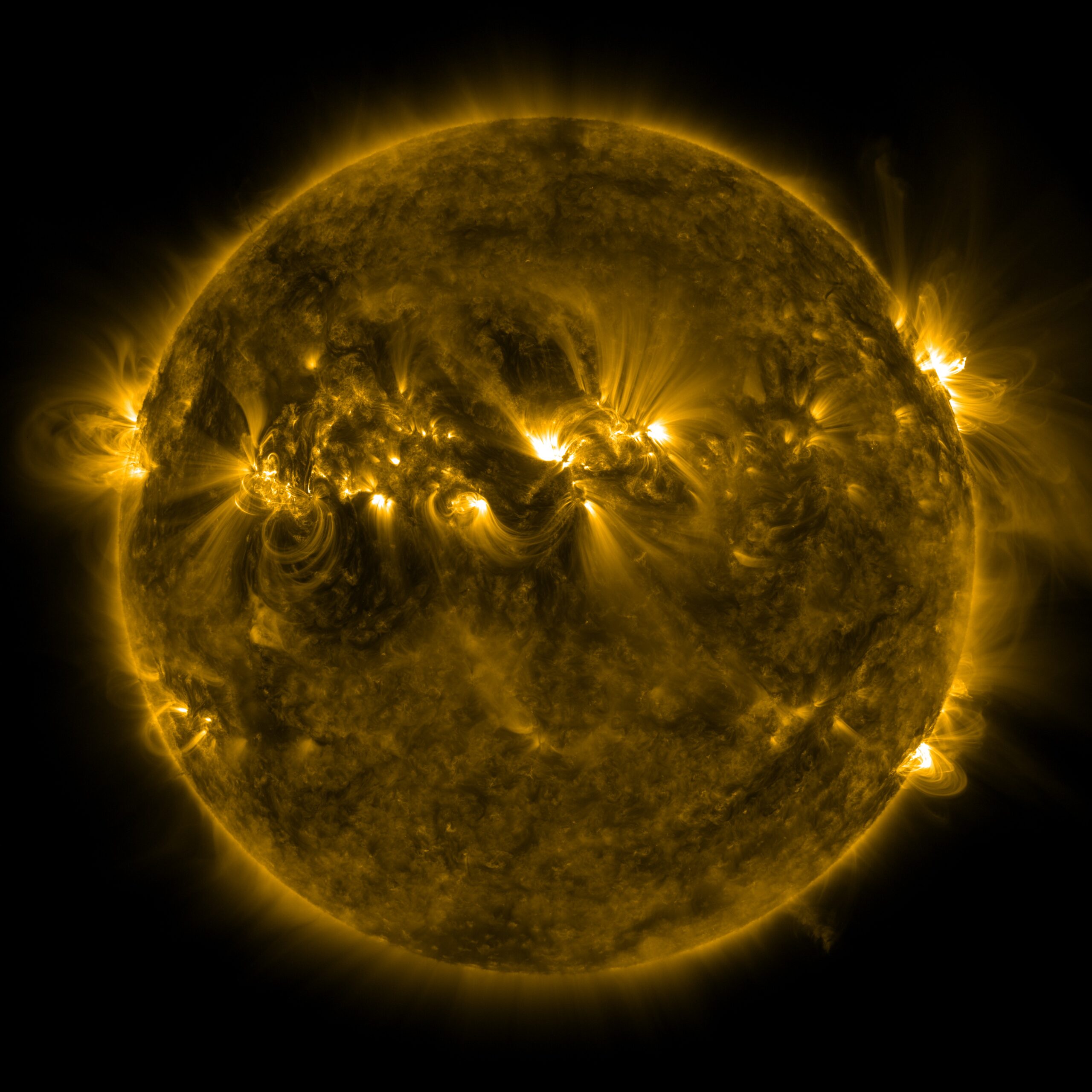Graphic of the sun, yellow solar flares and line shining from a sphere set against black background