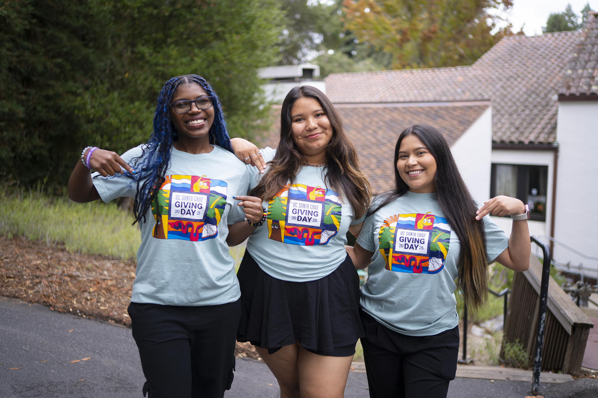 Students pose for a photo wearing Giving Day shirts.