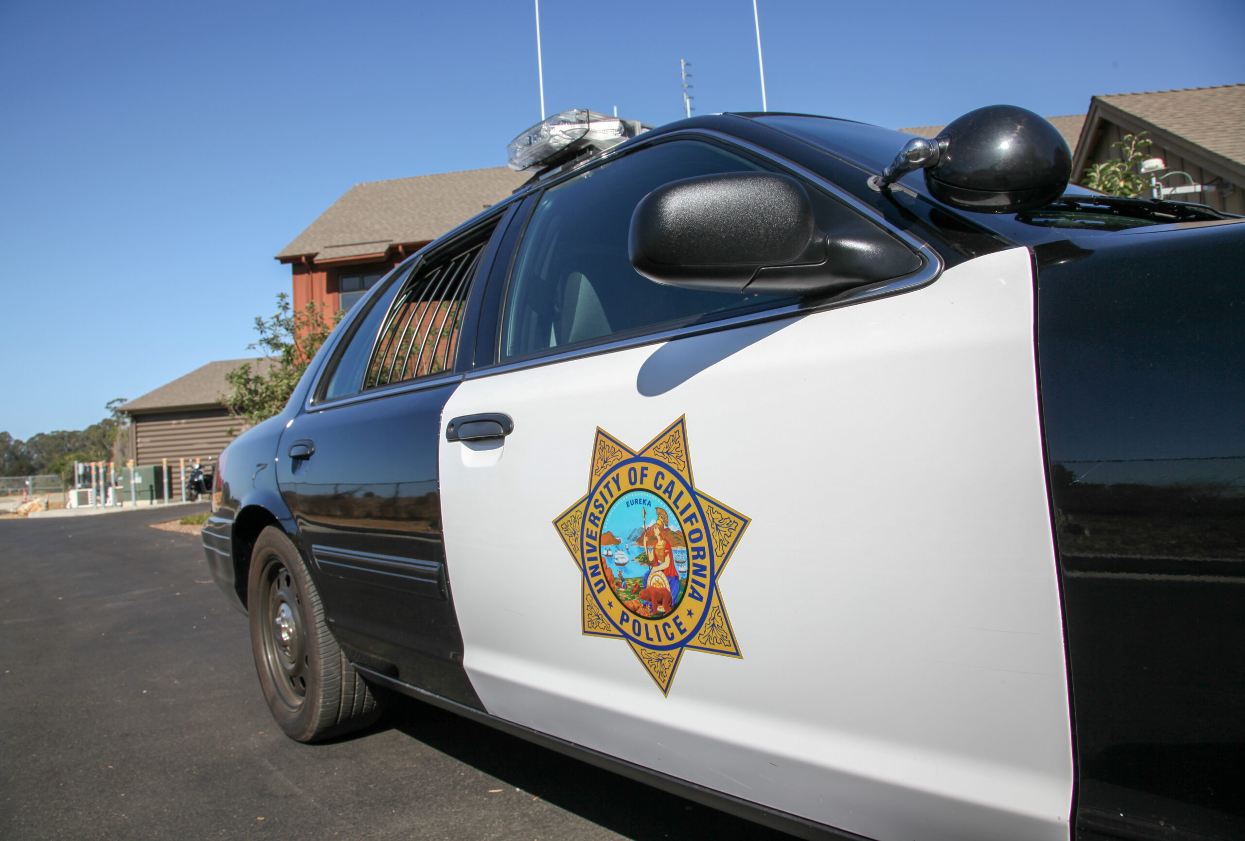 Left-side view of a UCPD vehicle - black and white with emblem on the door.