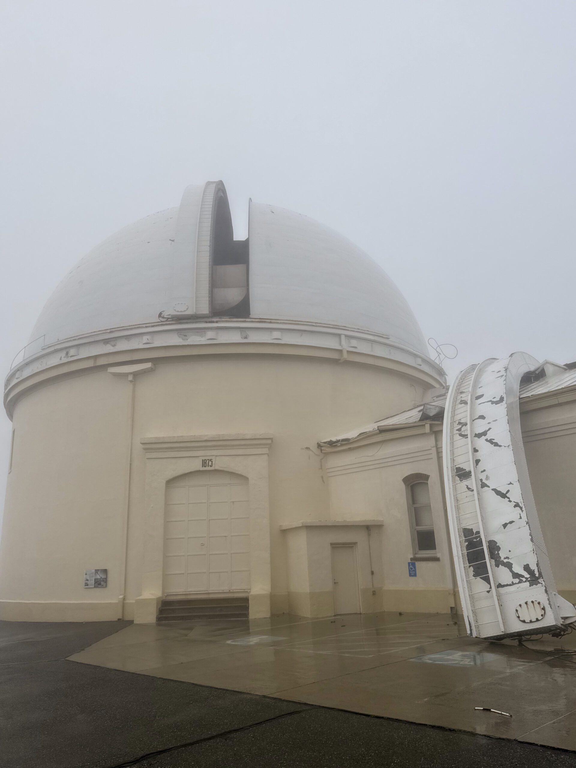 Exterior of observatory with part of the shutter on top of an adjacent building.