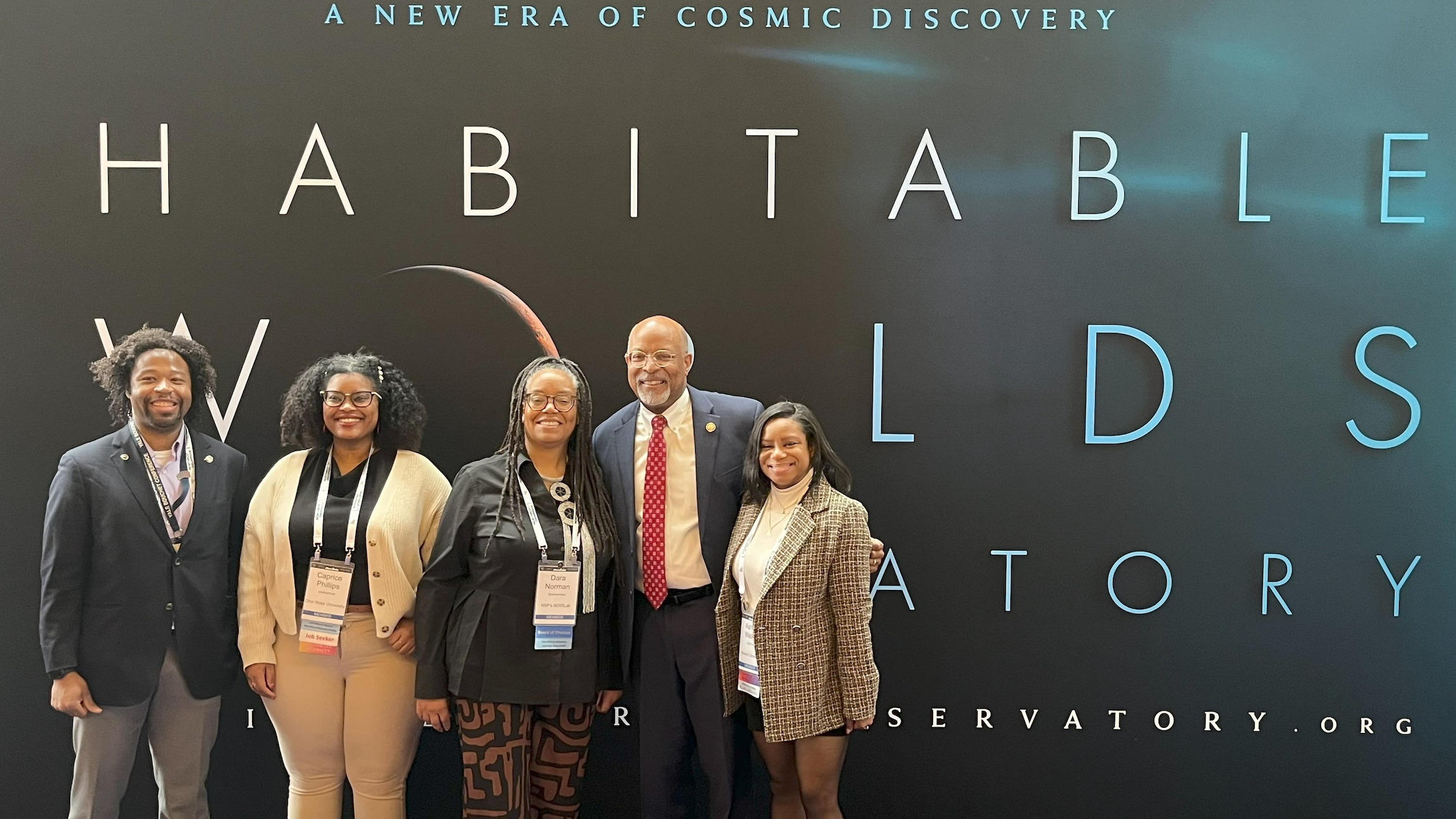 Group standing in front of exhibit sign