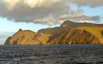 The green, mountainous coastline of Saint Helena Island, as seen from the ocean.