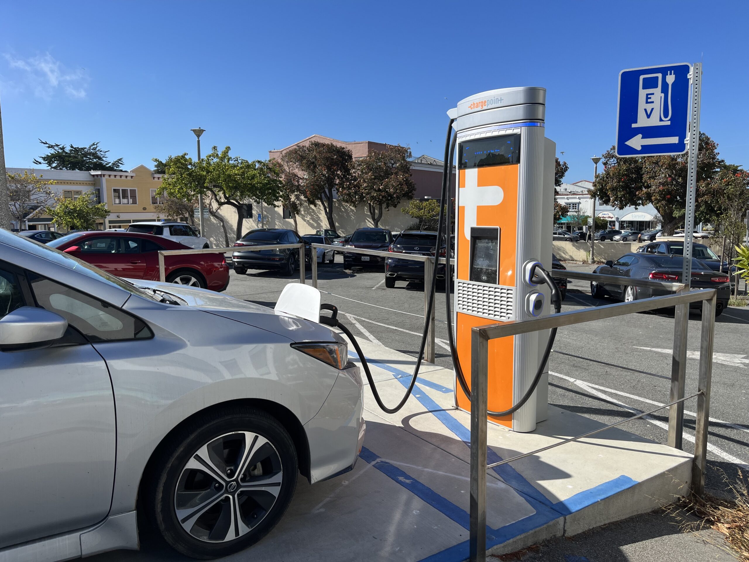 Electric vehicle plugged at at fast-charge station